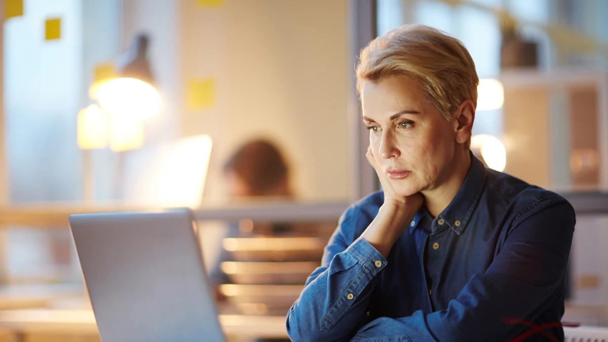 Woman looking at laptop in office setting